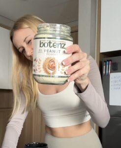 customer holds the peanut butter botenz powder jar